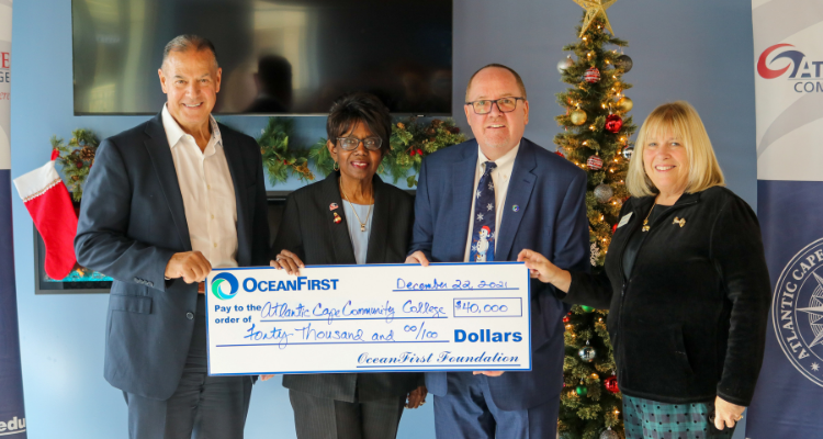 OceanFirst Foundation Board member Dr. Robert A. Previti, who is also a Trustee at Atlantic Cape Community College; Atlantic Cape President Dr. Barbara Gaba; Jeff Ropiecki, OceanFirst’s vice president of commercial lending; and Foundation Executive Director Jean McAlister hold up a check for the donation at the Mays Landing campus on Dec. 22, 2021.